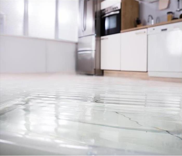 Water damage on a white kitchen floor