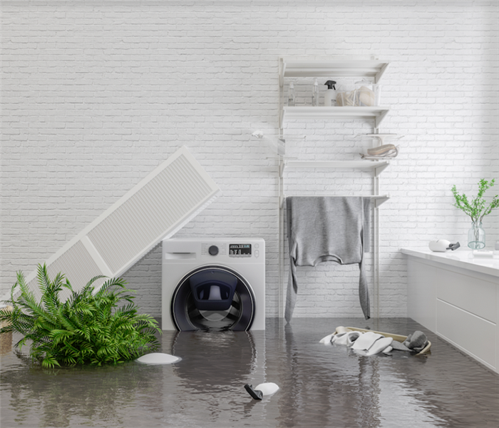 a water damaged laundry room with water covering the floor